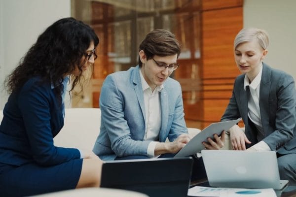 Business team discussing client relationship management strategies in a meeting