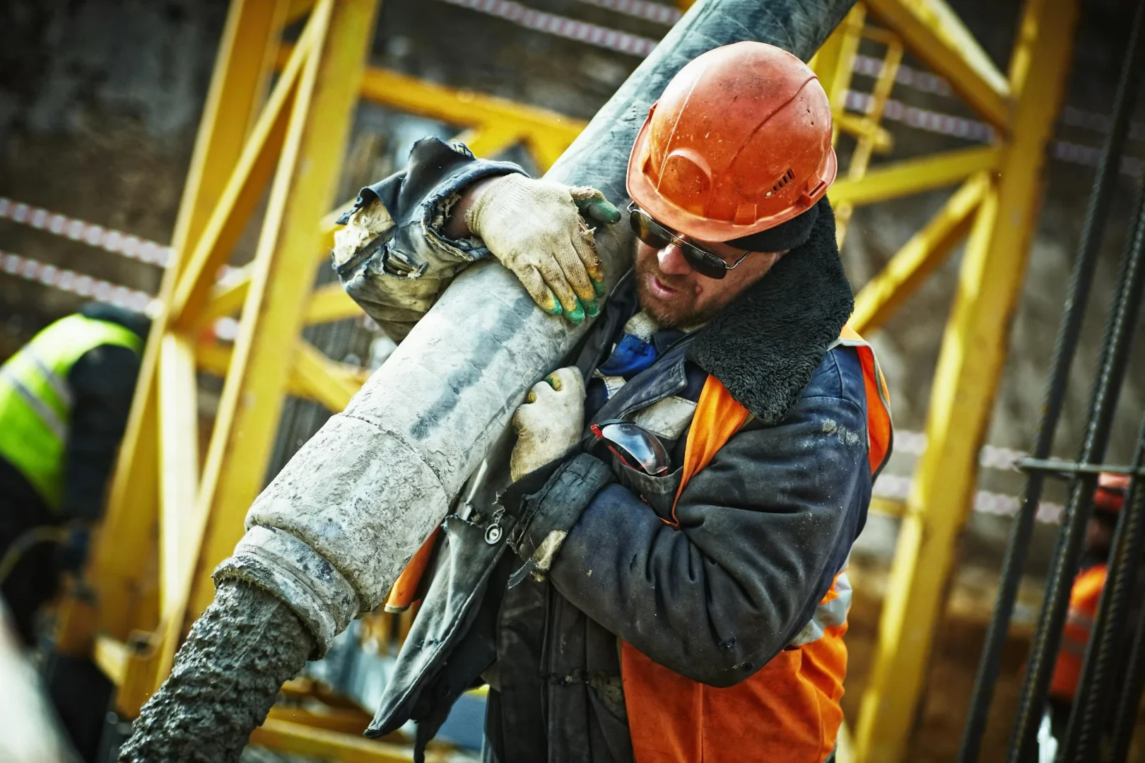 Construction professional using project management software on tablet at job site