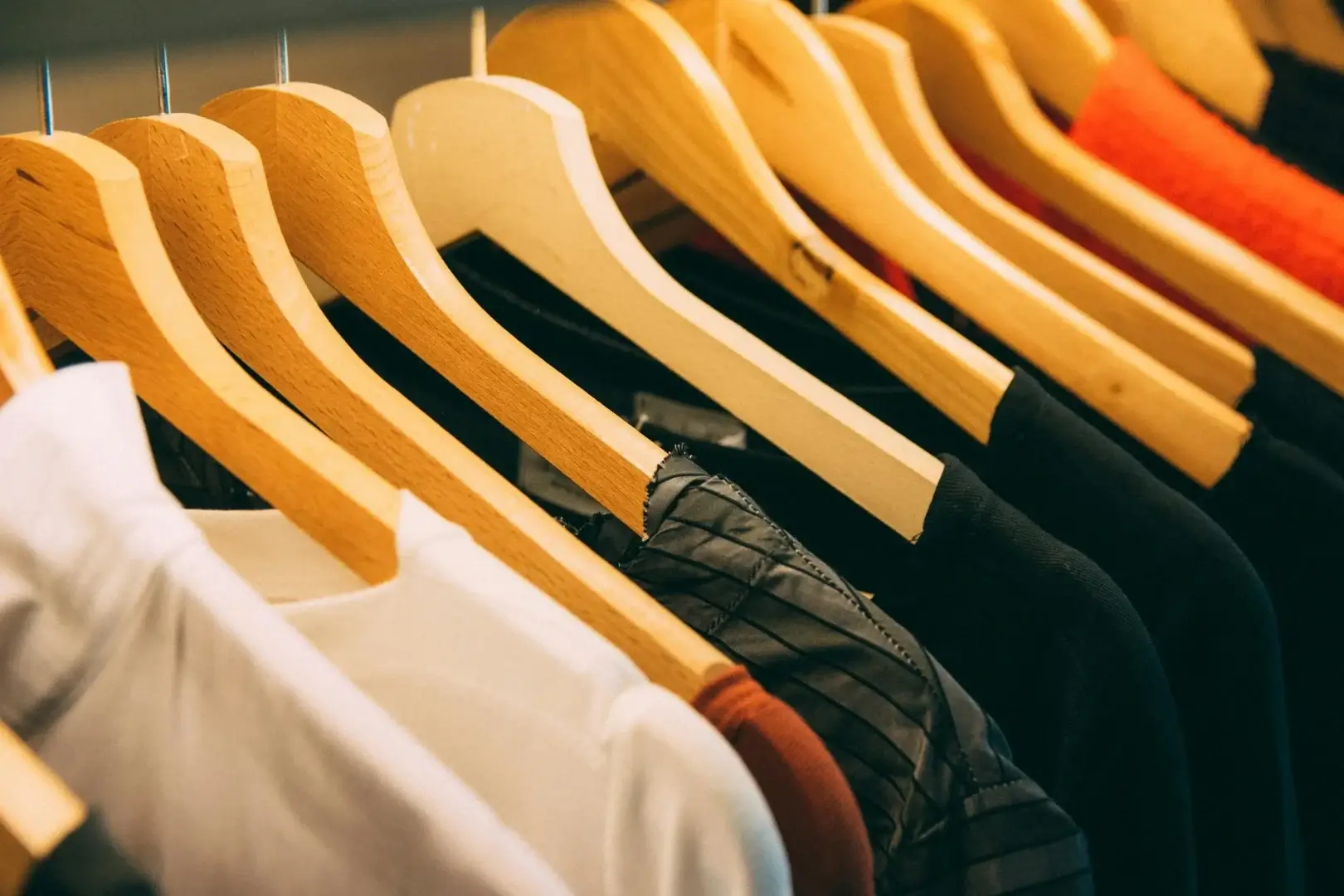 Folded custom printed t-shirts stacked on a wooden table