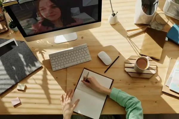Person chatting with an AI assistant on a laptop to design a website
