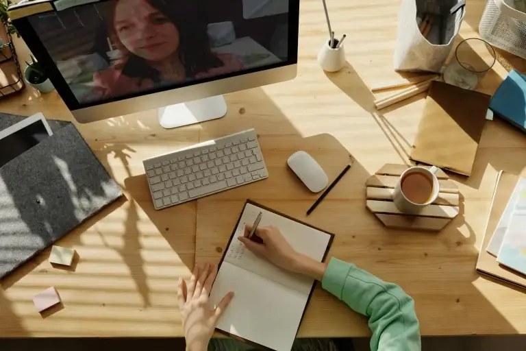 Person chatting with an AI assistant on a laptop to design a website
