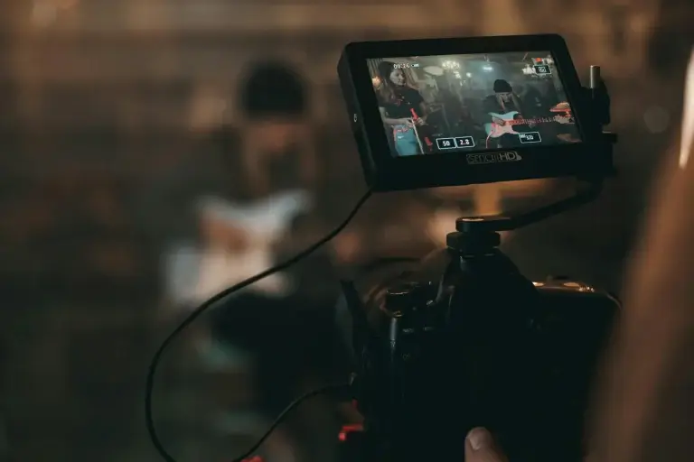Video editor working with stock footage on a multi-monitor editing workstation