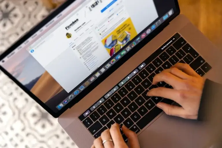 Hands typing on laptop representing GetResponse vs Mailchimp email marketing comparison