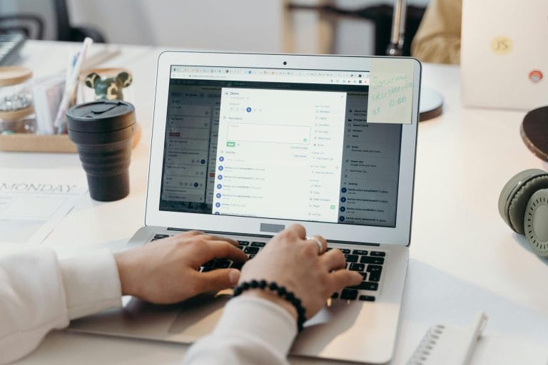 Person typing cold email on laptop comparing Lemlist and Instantly platforms