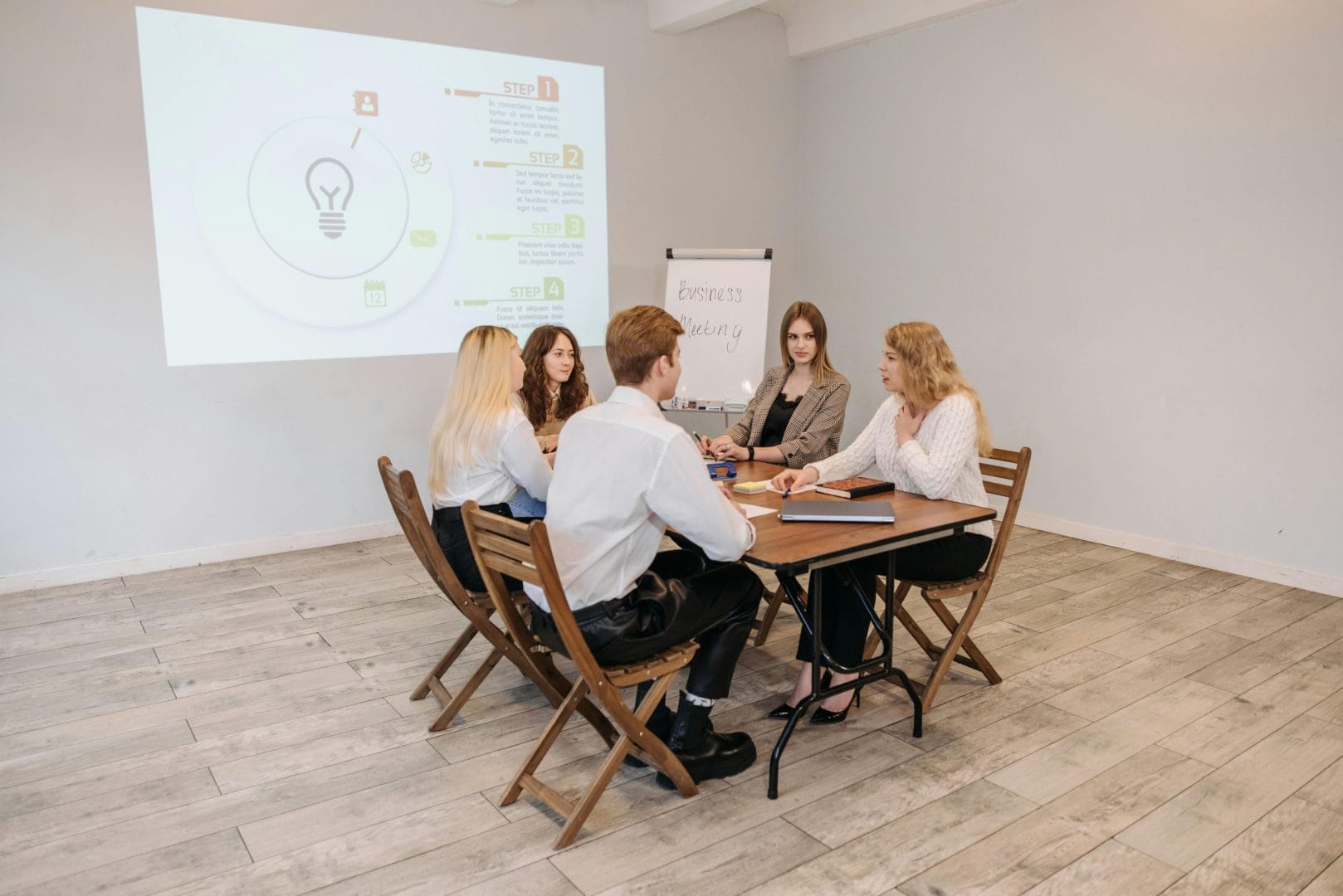 Business meeting with presentation screen comparing AI presentation tools