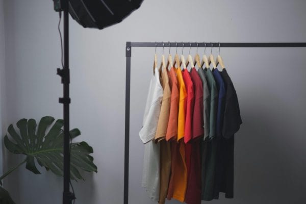 Colorful t-shirts on rack representing print on demand merchandise