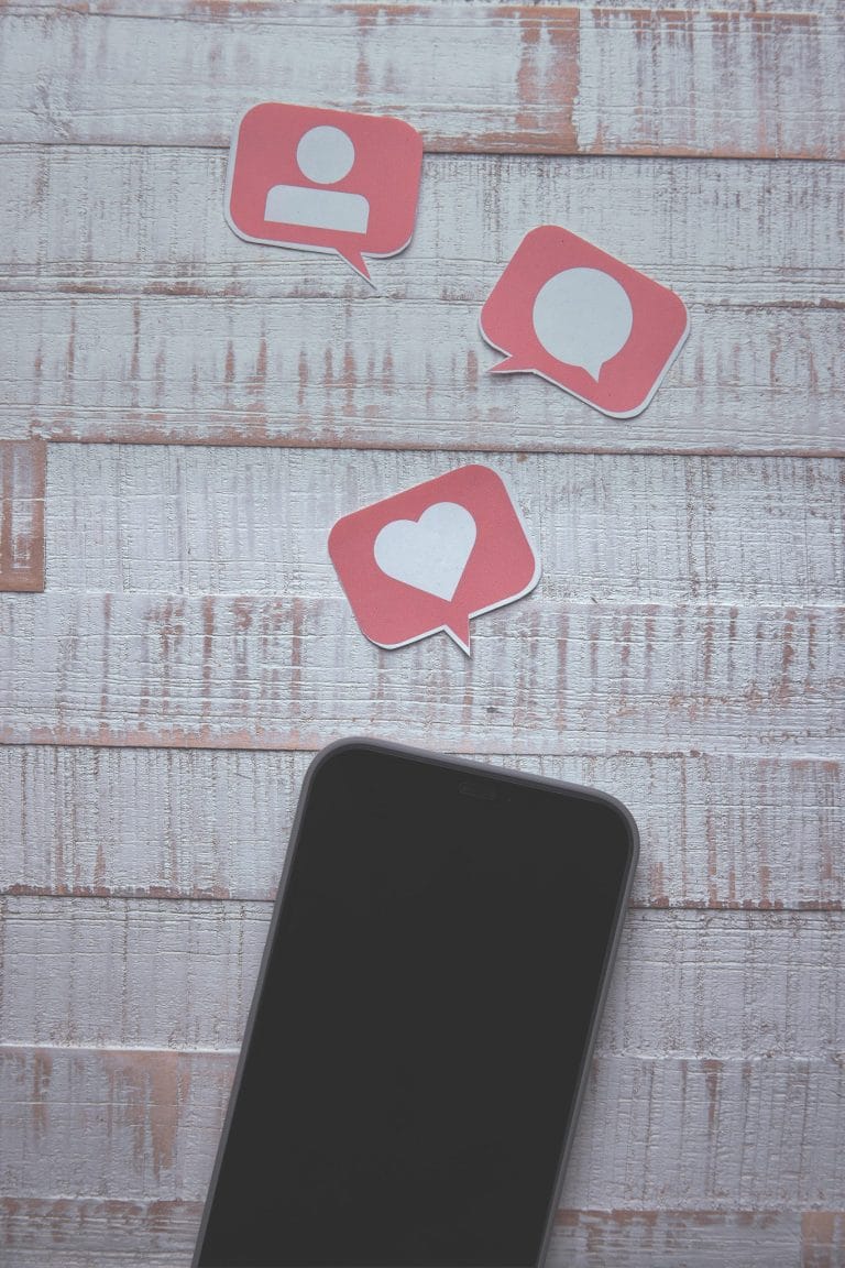 Smartphone with social media icons representing chat marketing platforms
