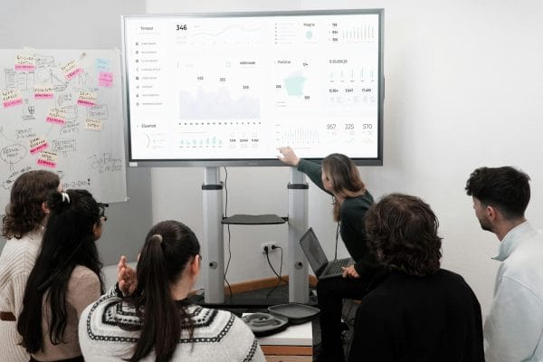 Sales team analyzing charts on screen representing B2B data platform comparison