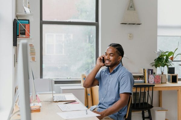 Professional on business phone call representing paid vs free phone service comparison
