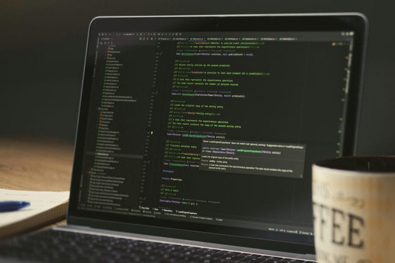Laptop displaying code representing AI coding platform comparison