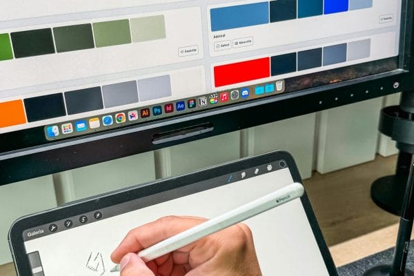 Digital designer working with stylus and tablet representing stock visual marketplace comparison