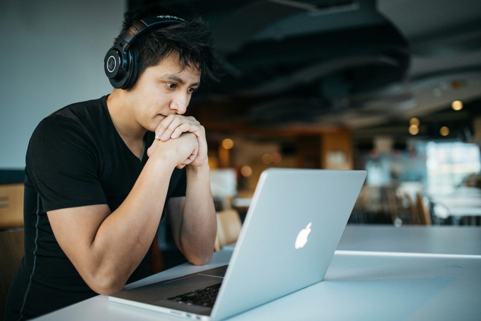 Person studying an online course on a laptop, representing a WordPress LMS comparison between LearnDash, Tutor LMS, and Learnomy